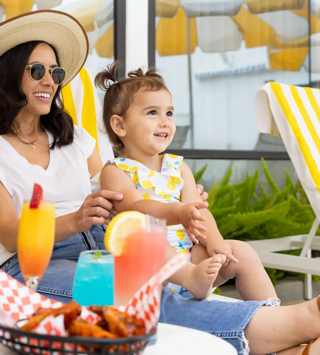 A family enjoying colorful drinks by the pool